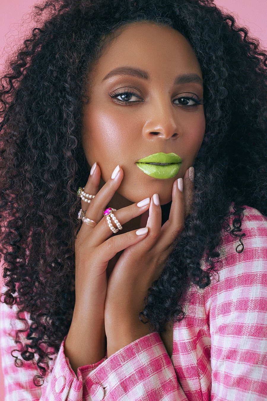 Creative beauty: lime-green lips, curly hair, radiant complexion
