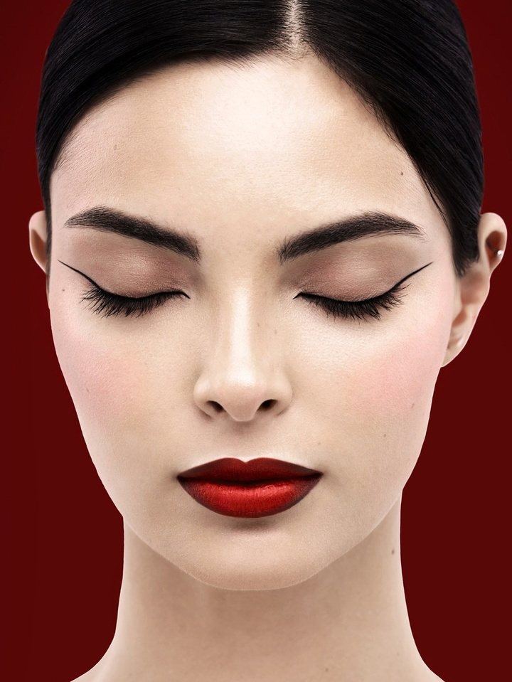 Graphic liner and a classic red lip against deep red